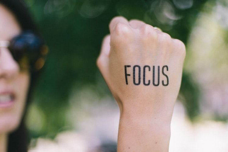 Woman with the word 'focus' written on her fist