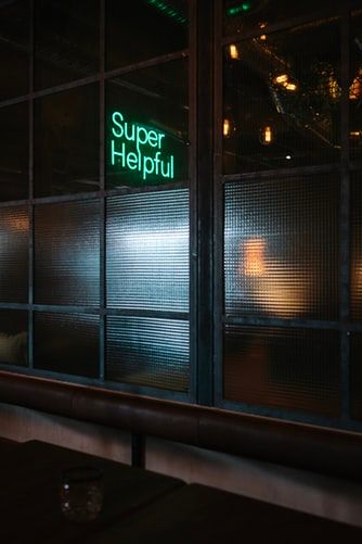 Neon sign saying 'super helpful'