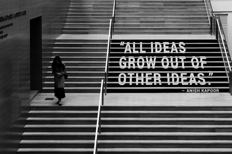 Sign on flight of stairs saying 'all ideas grow out of other ideas'