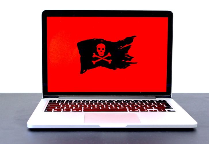 Laptop with a Jolly Rodger pirate flag on the screen