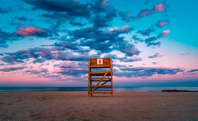 Lifeguard chair on a beach at sunset