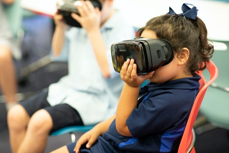 Children wearing VR headsets