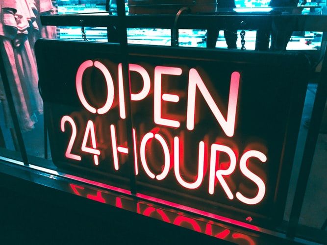 Neon sign saying 'open 24 hours'