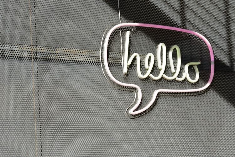 Neon sign saying 'hello' in speech bubble