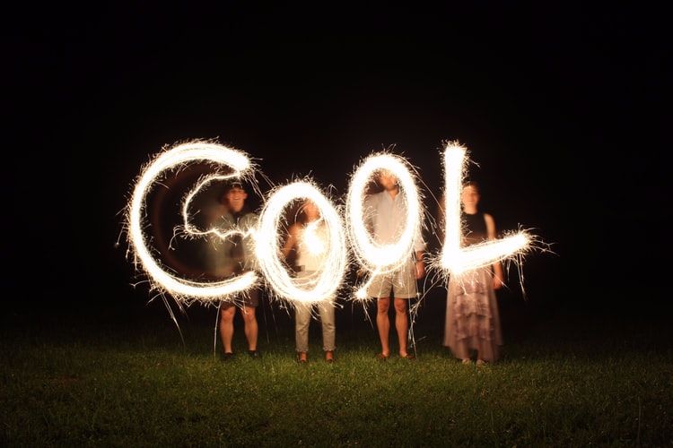 People spelling the word 'cool' with sparklers