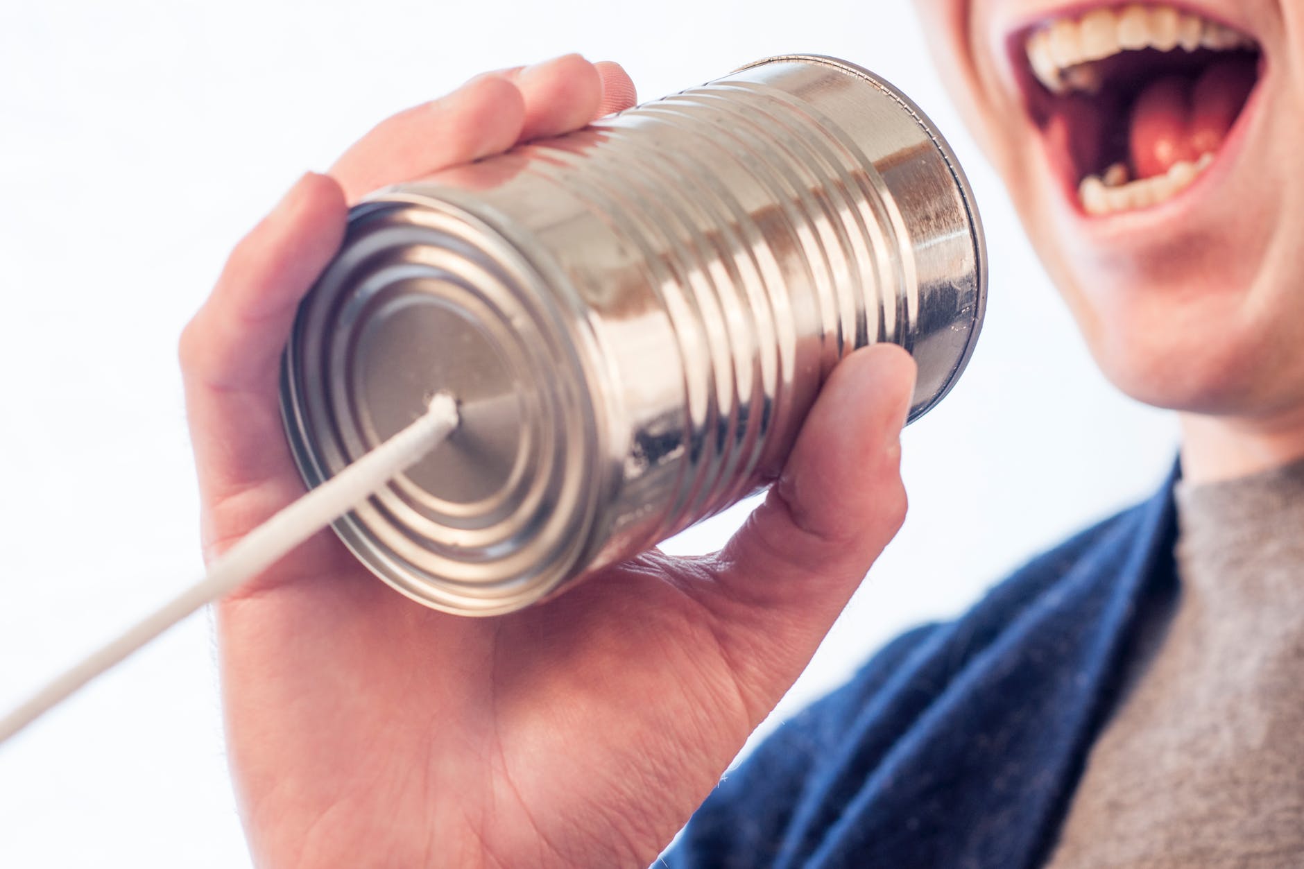 Man shouting into tin can 'telephone'
