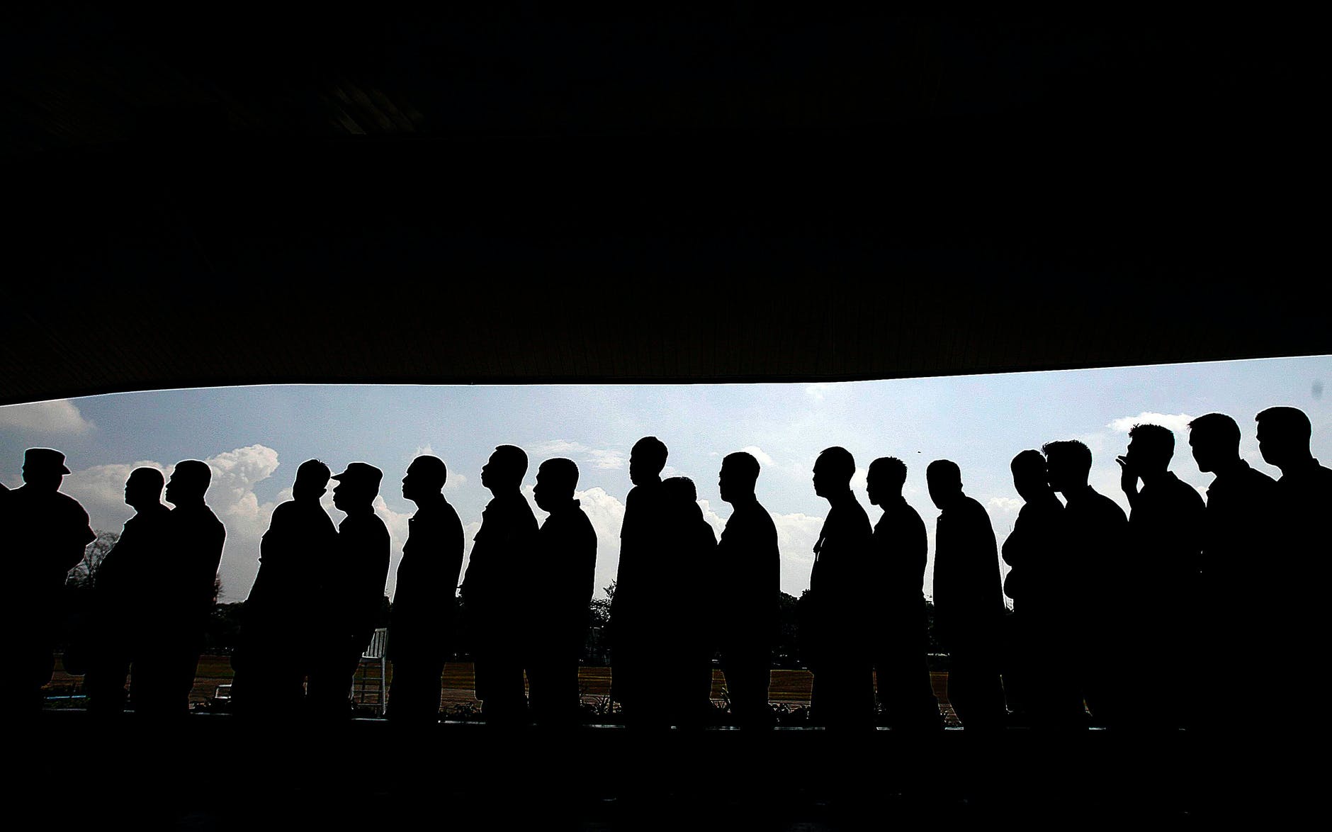 Silhouette of people waiting in line