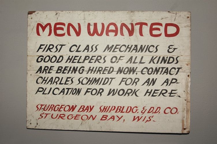 Vintage 'men wanted' sign looking for workers at a shipyard 