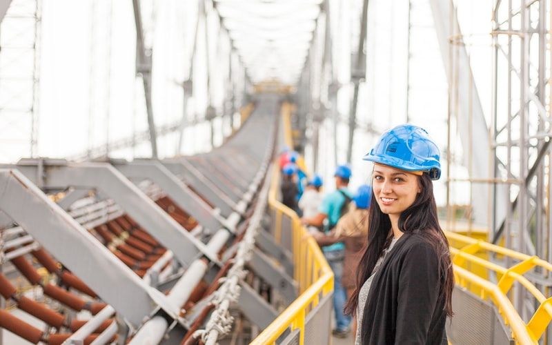Woman wearing a hard hat smiling at the camera