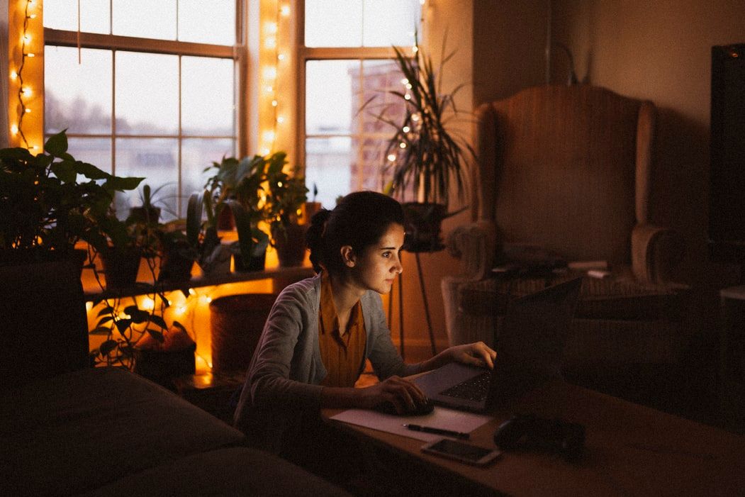 Woman working from home surrounded by houseplants