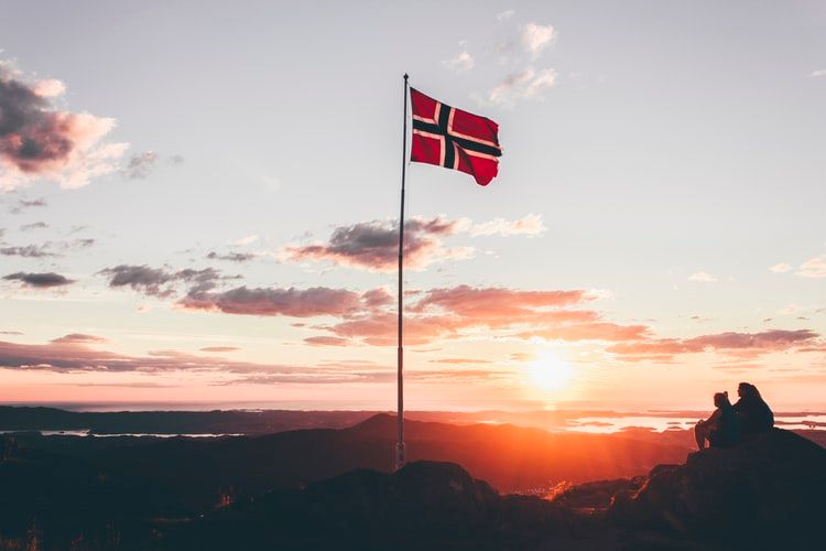The Norwegian flag on a hill at sunset