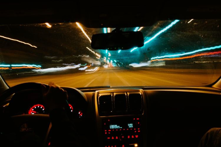 View of a road at night from a car's dashboard