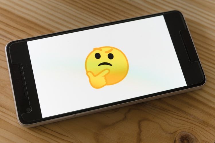 The thinking emoji on a phone screen