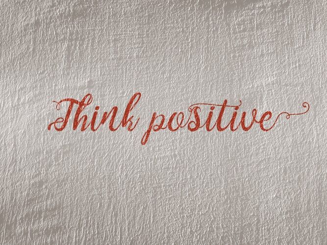 The words 'think positive' in red on a white background