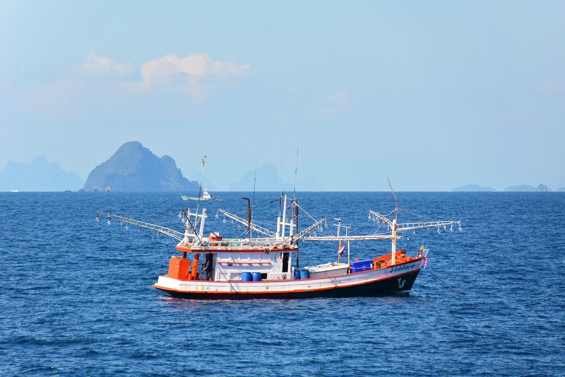 Fishing vessel with islands in the background