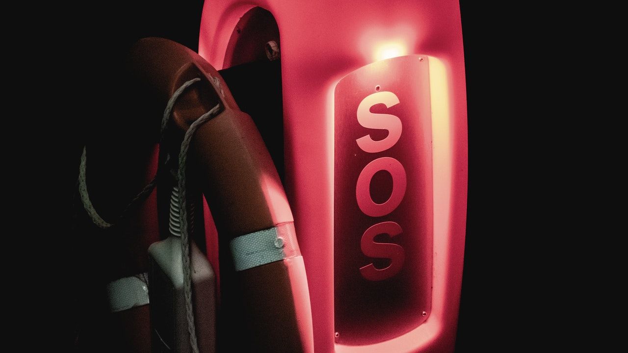Lifebuoy and red illuminated SOS sign