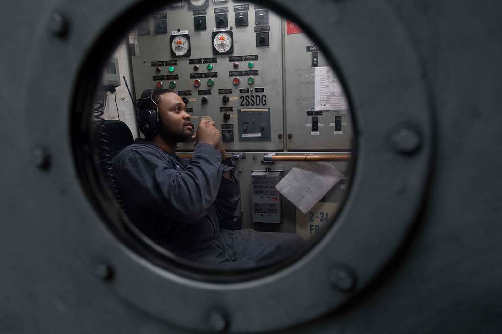 View of an engineer through a porthole in a door