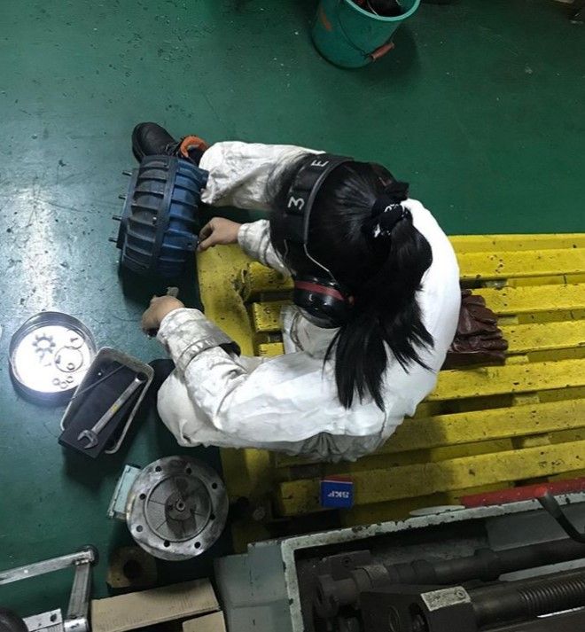 Female seafarer working on equipment