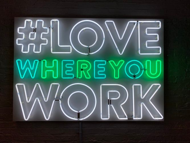 Neon sign saying love where you work