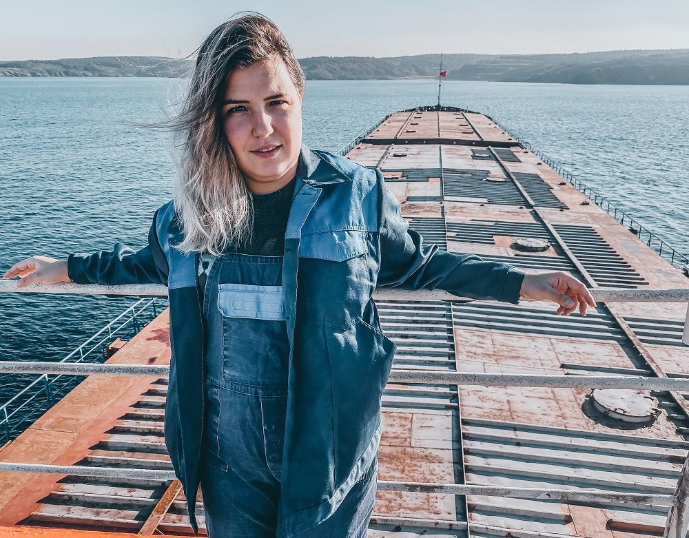 Female seafarer standing on the deck of her ship