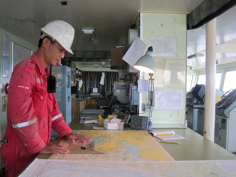 A seafarer looking at a map