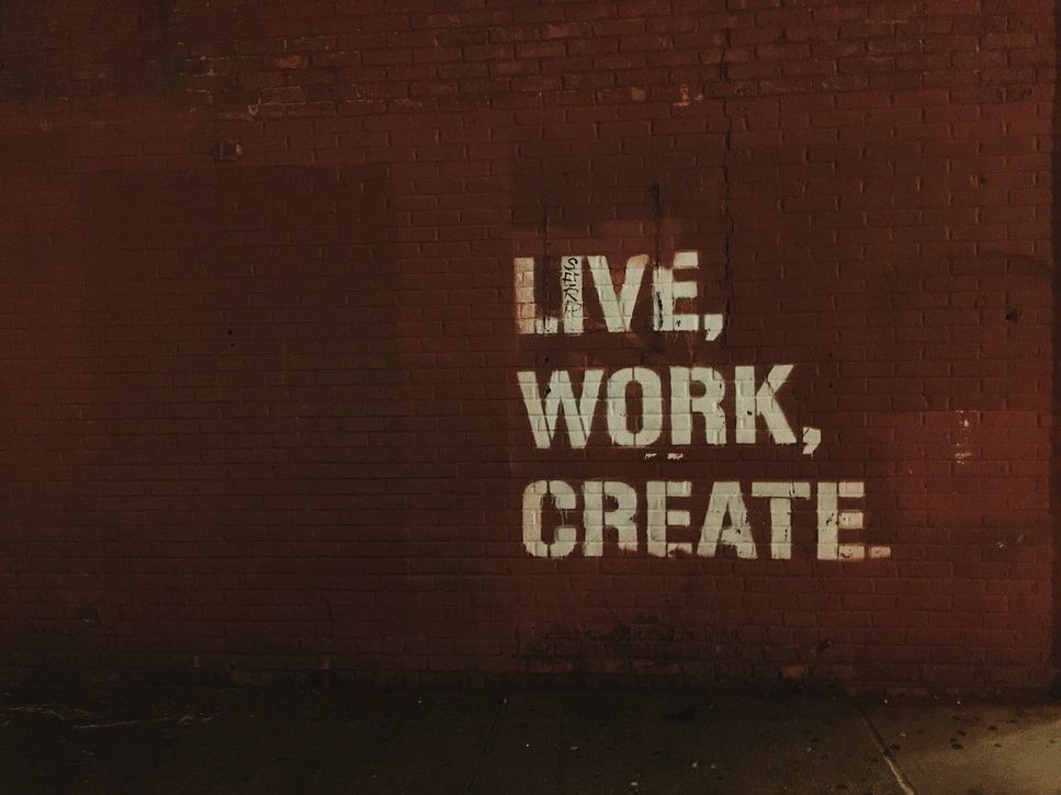 Stencil on  wall saying ;live, work, create'