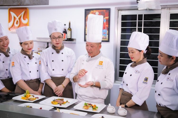 Group of chefs discussing dishes