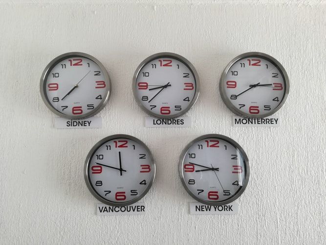 Five clocks set to different time zones