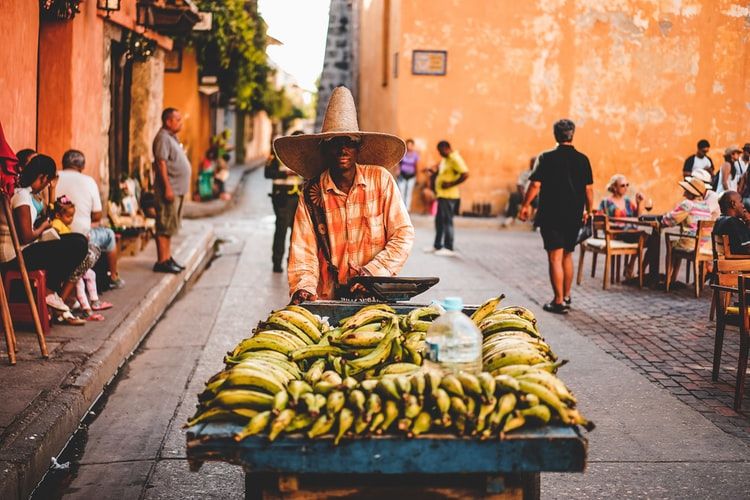 Man with a mobile market stall of bananas