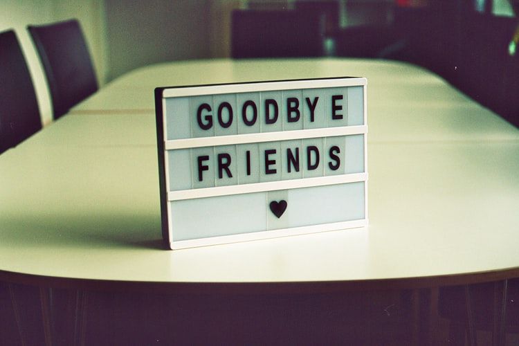 Sign on a meeting room desk saying 'goodbye friends'