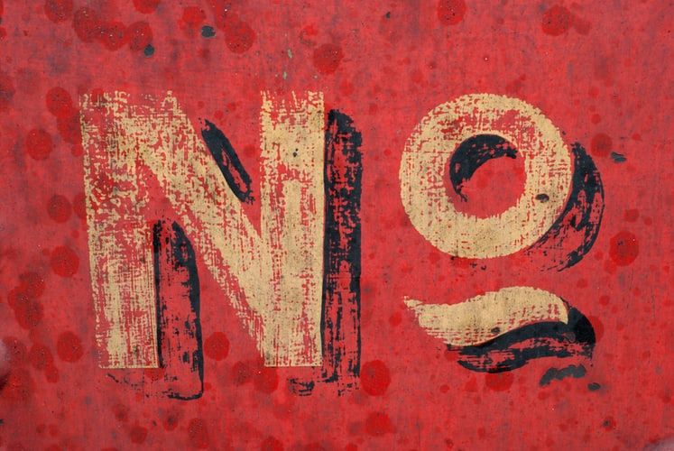 The word 'no' painted on a red wall
