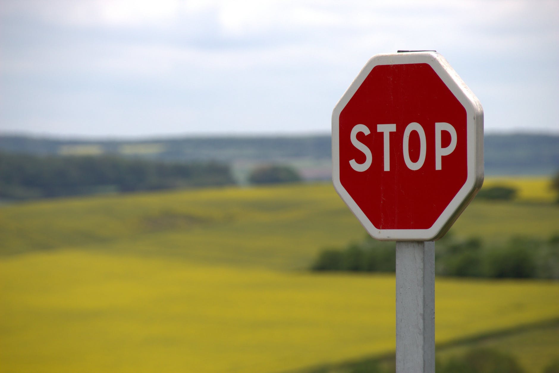 Stop sign in front of countryside