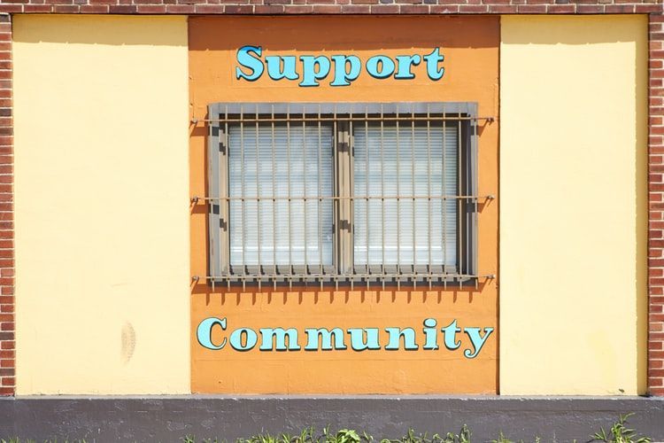 Window with the words 'support community' above and below it