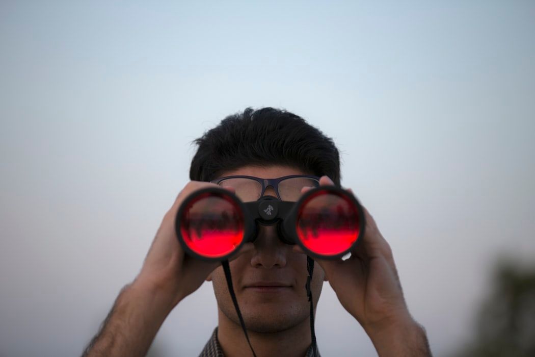 Man looking through binoculars 