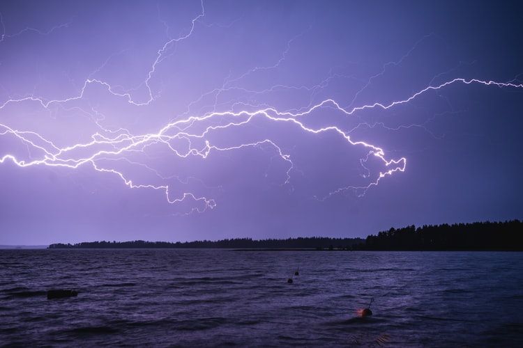 Lightning striking over a body of water