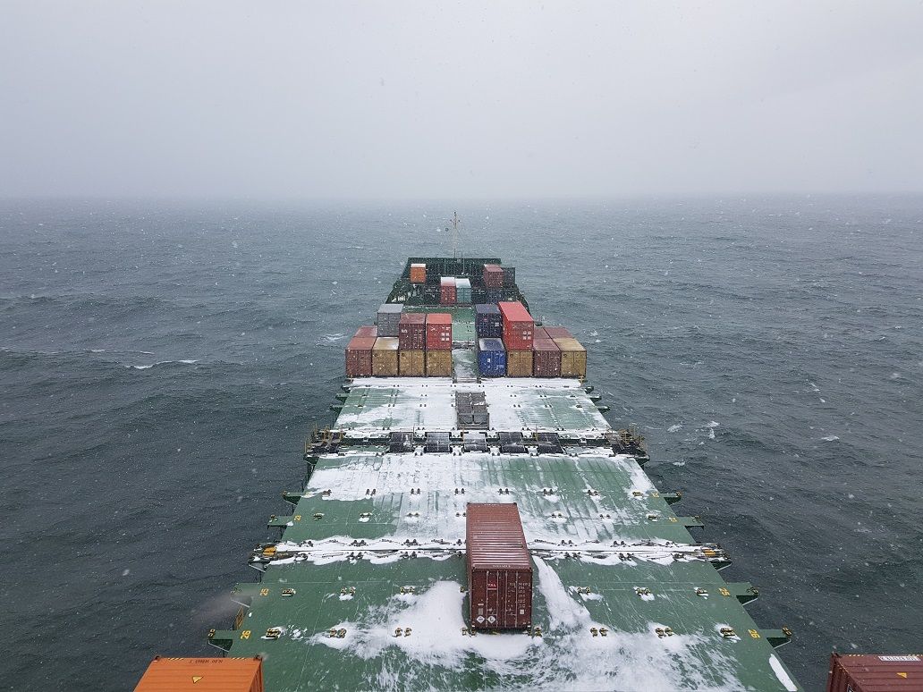 View of the deck of a cargo ship taken from the bridge