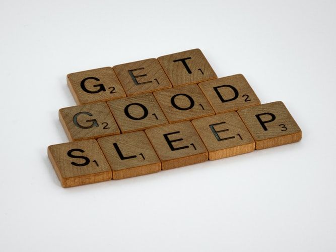 Scrabble tiles spelling out 'get good sleep'