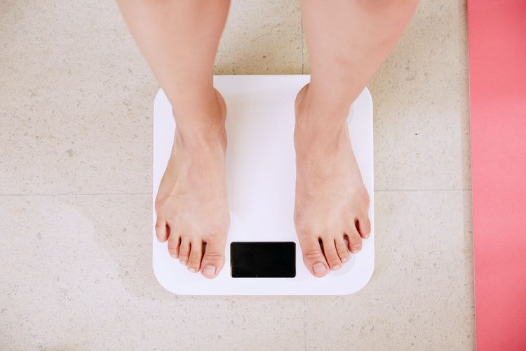 Person standing on weighing scales