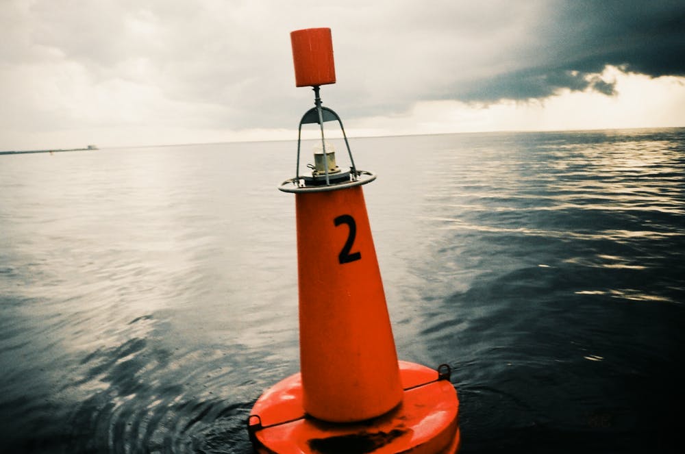 An orange buoy in the ocean
