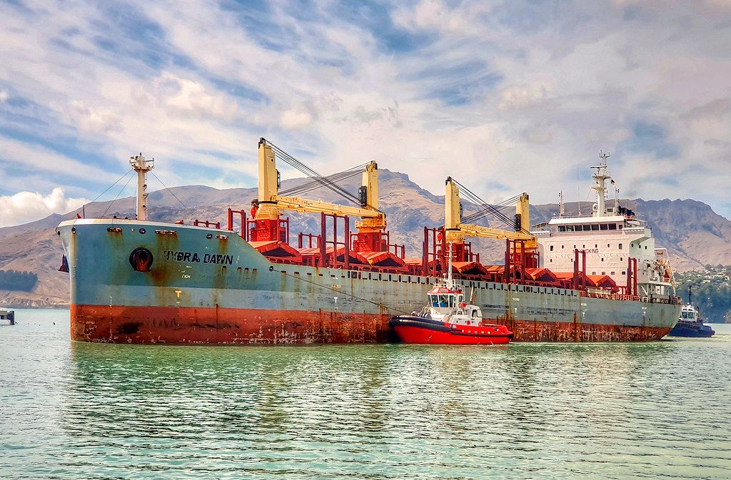 A bulk carrier with a backdrop of mountains