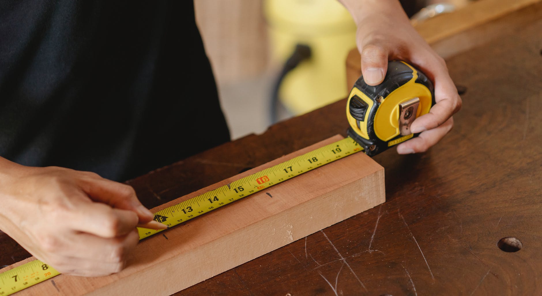 Man measuring a piece of wood 