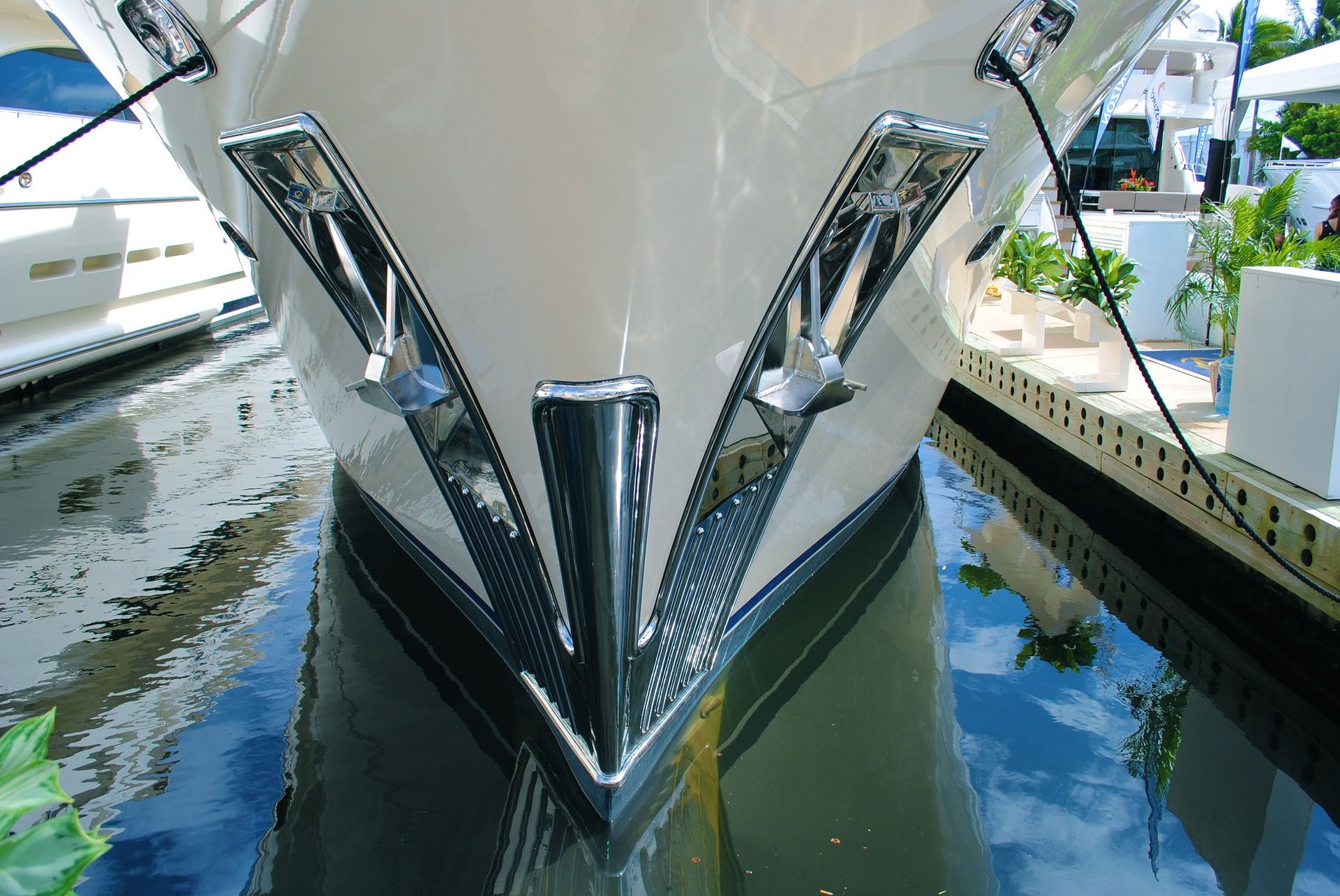 The bow of a superyacht moored in a harbor