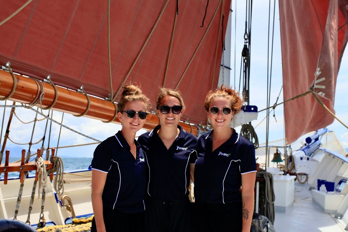 Three sailing yacht crew members