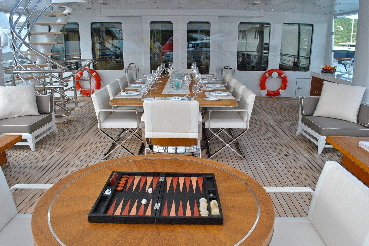 The deck of a superyacht with a backgammon board laid out ready to play