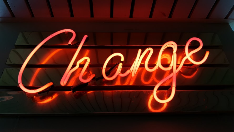 An orange neon sign saying 'change'