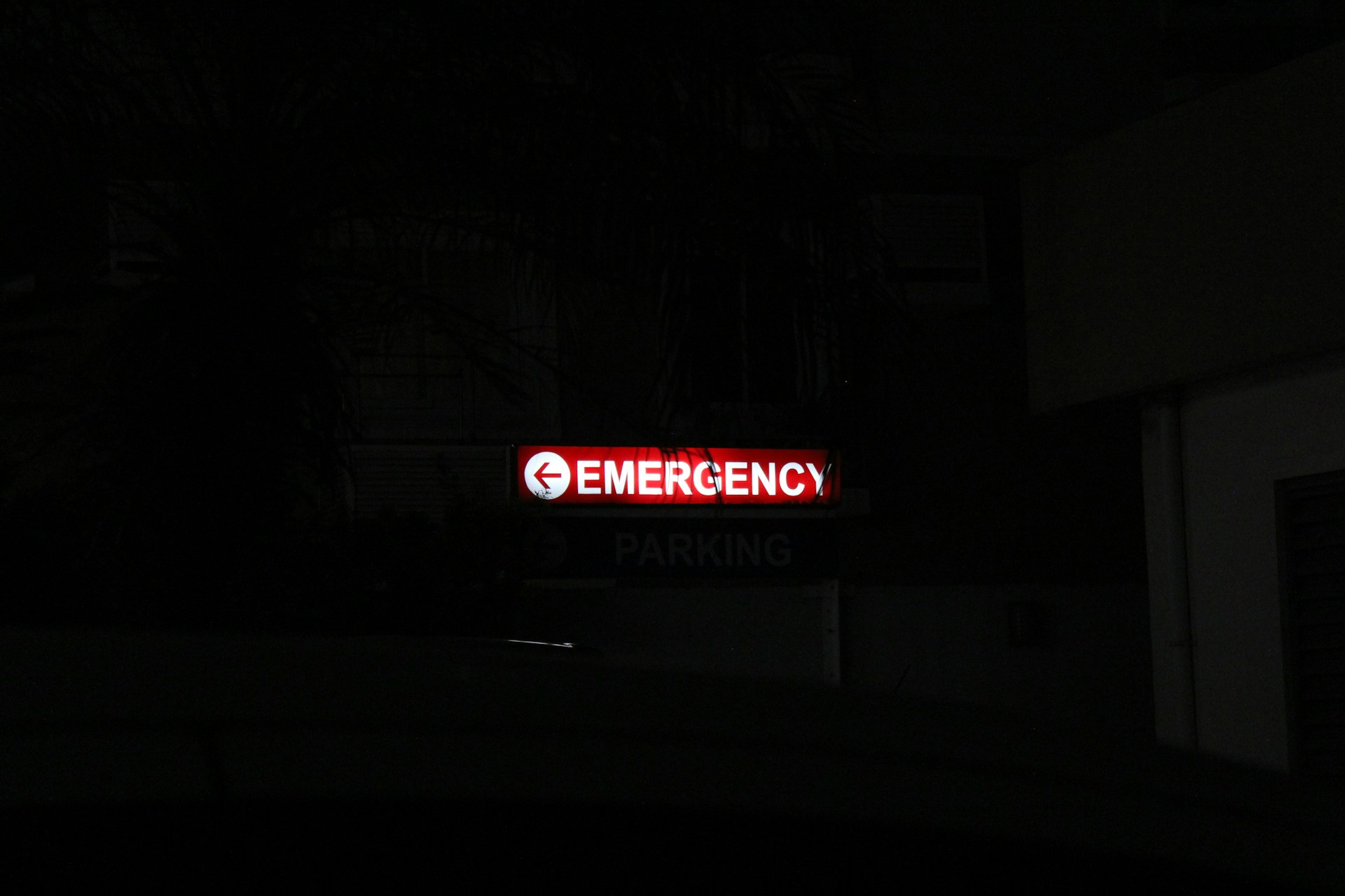 A red neon emergency sign