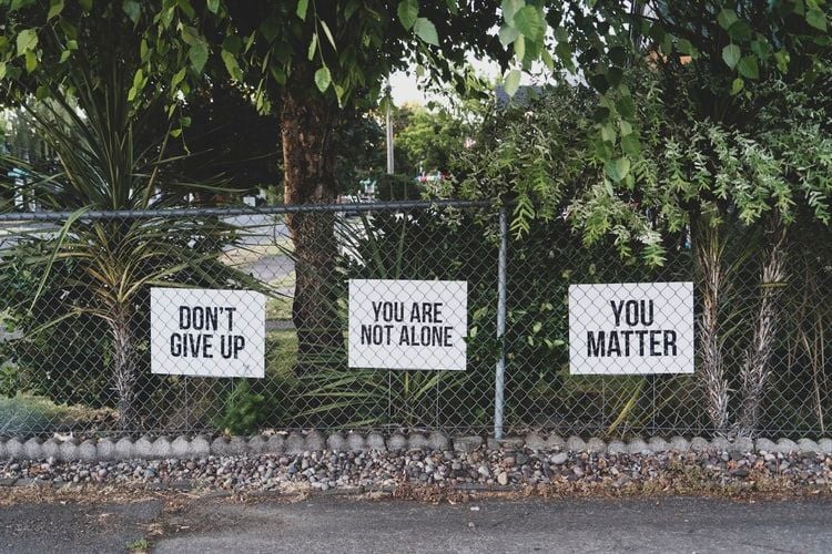 motivational signs on a fence