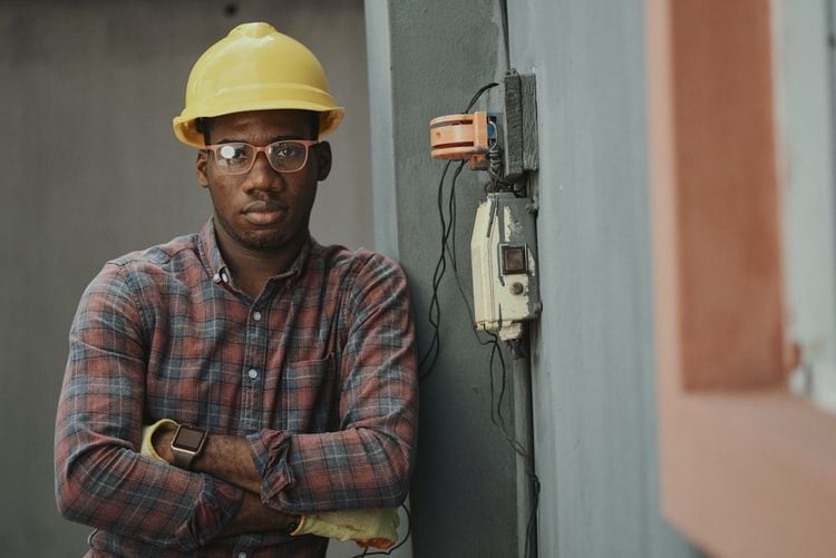 man in hard hat next to electrics