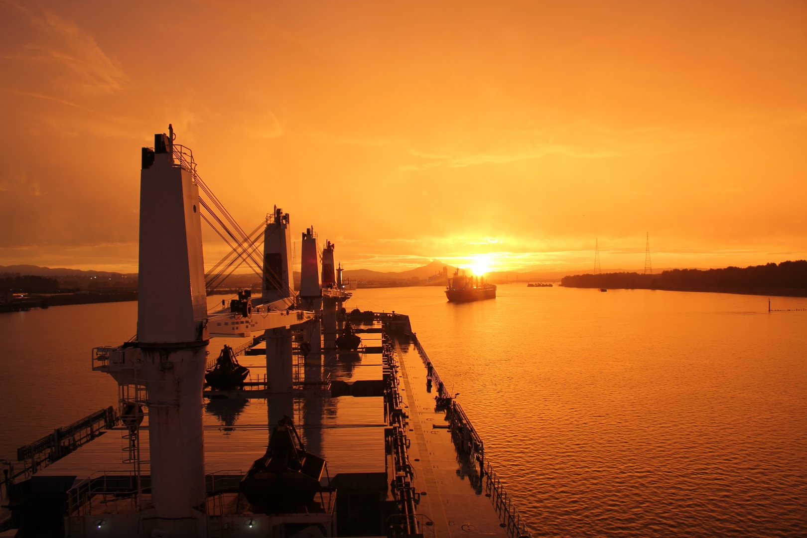 the view from the bridge of a bulk carrier at sunset