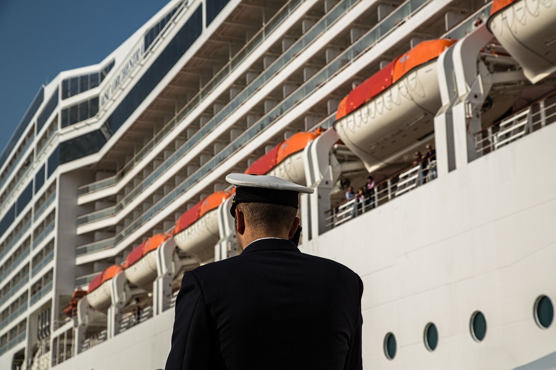 an officer walking past a cruise ship
